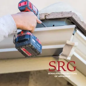 guy repairing gutter with a drill